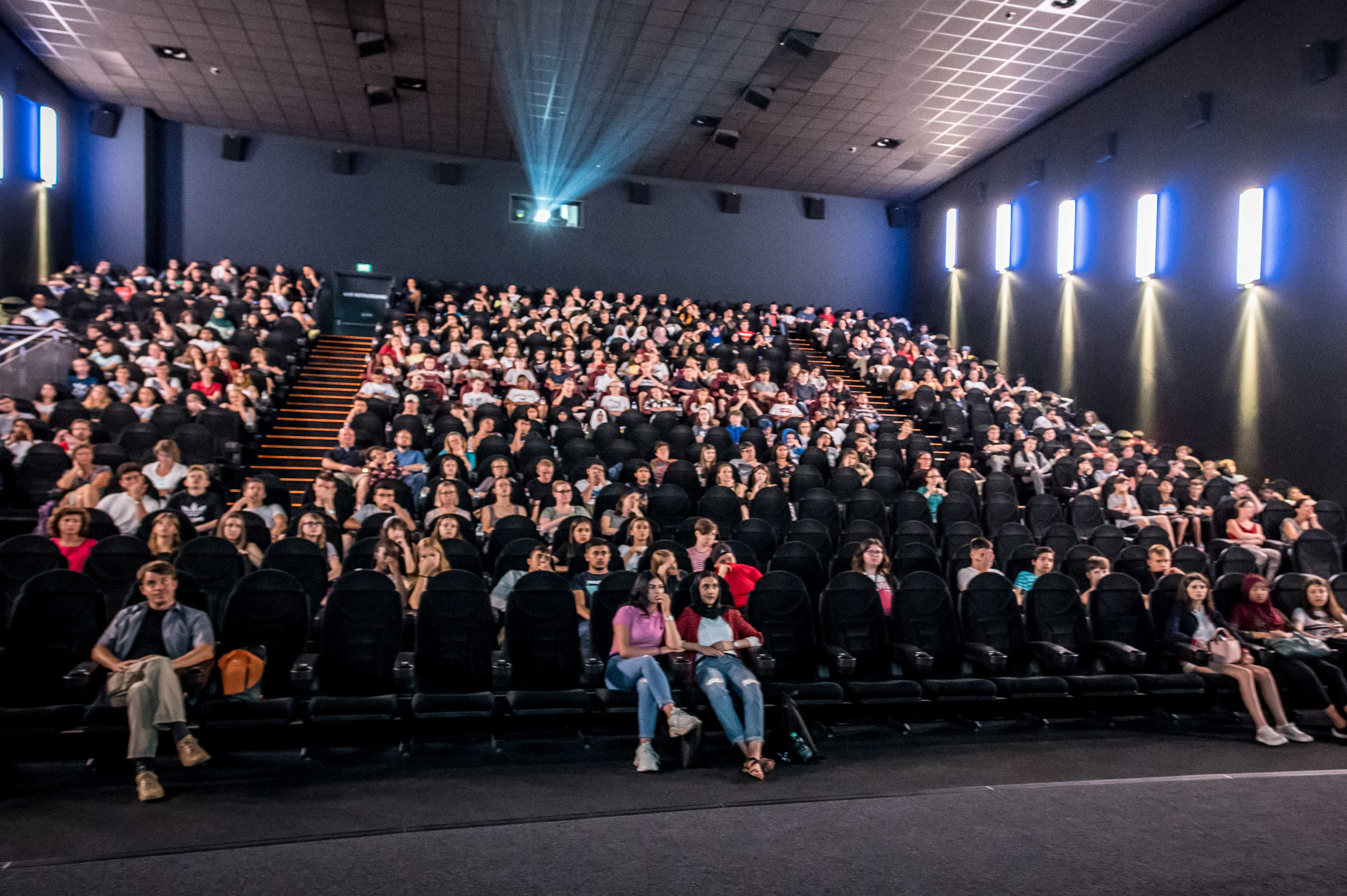 Eine Menge von Schülern sitzt im Kinosaal